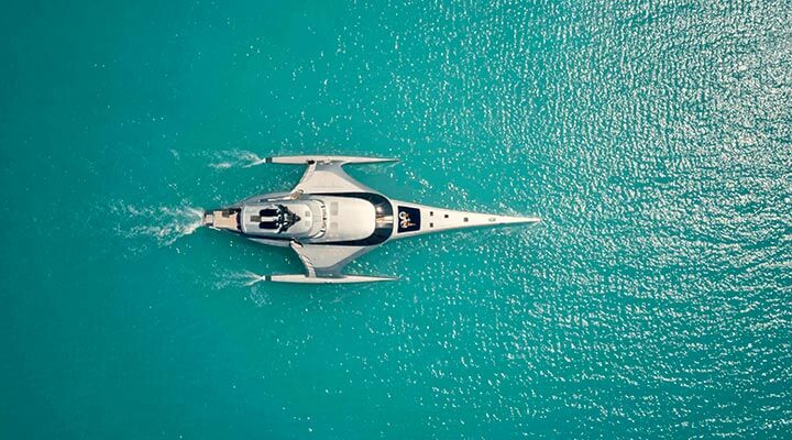 A superyacht sailing through the Mediterranean sea on a luxury travel experience.