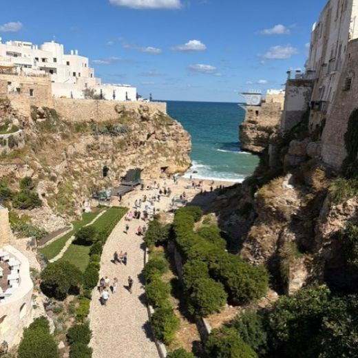 View down to Lama Monachile beach between limestone cliffs in Polignano a Mare, Puglia
