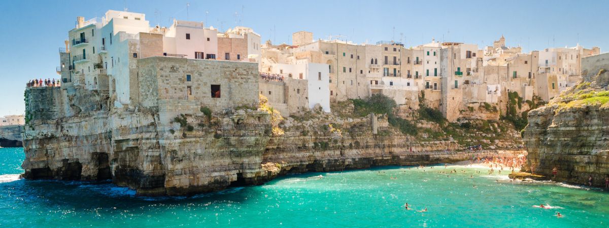 Whitewashed clifftop houses of Polignano a Mare above the turquoise Adriatic Sea in Puglia, Italy